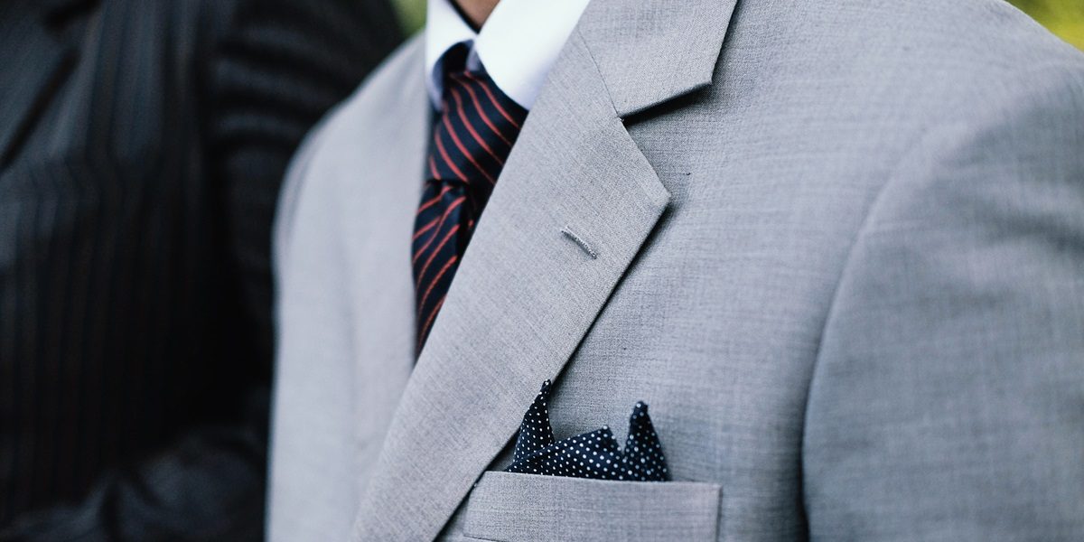 Image commercially licensed from: https://unsplash.com/photos/man-wearing-gray-notched-lapel-suit-jacket-standing-MujZAKea8Lw